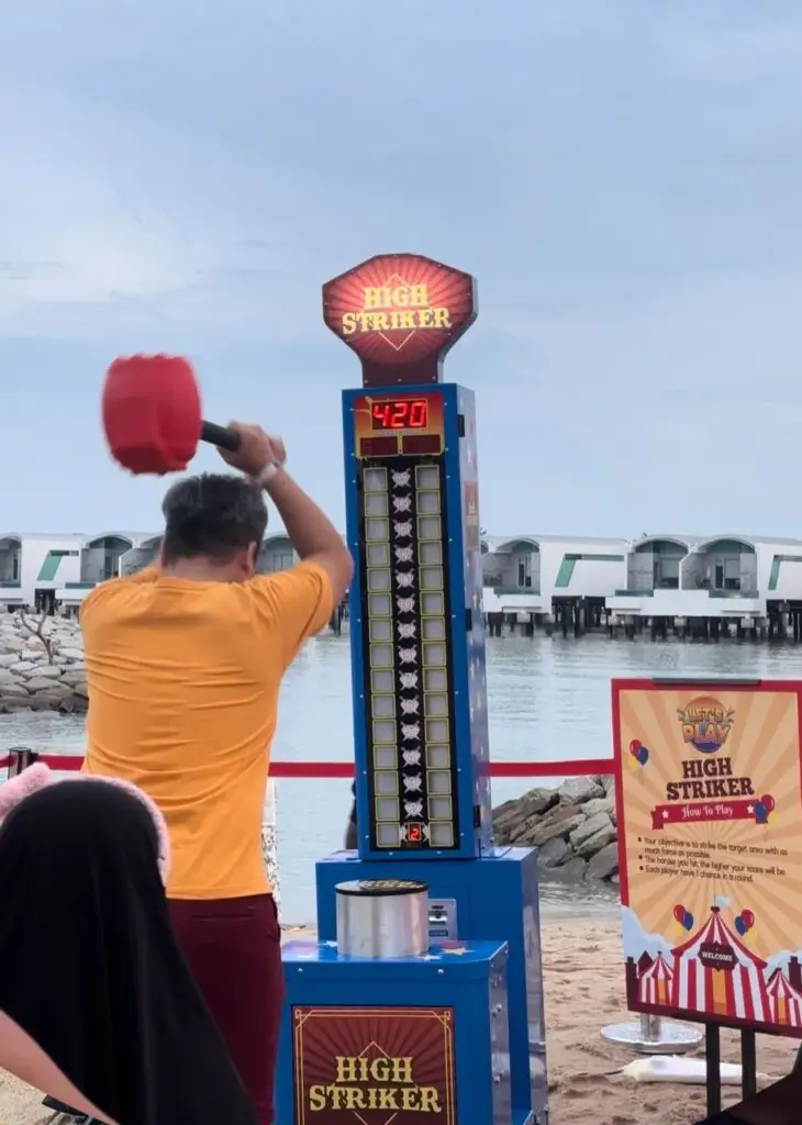 Hammer Machine Challenge - Participants take a swing with the hammer, testing their strength as they aim to reach the top of the meter. Ideal for showcasing might and friendly competition at events and parties.