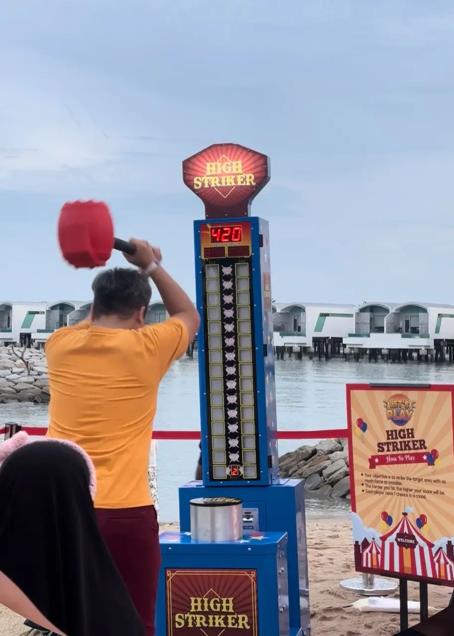 Hammer Machine Challenge - Participants take a swing with the hammer, testing their strength as they aim to reach the top of the meter. Ideal for showcasing might and friendly competition at events and parties.