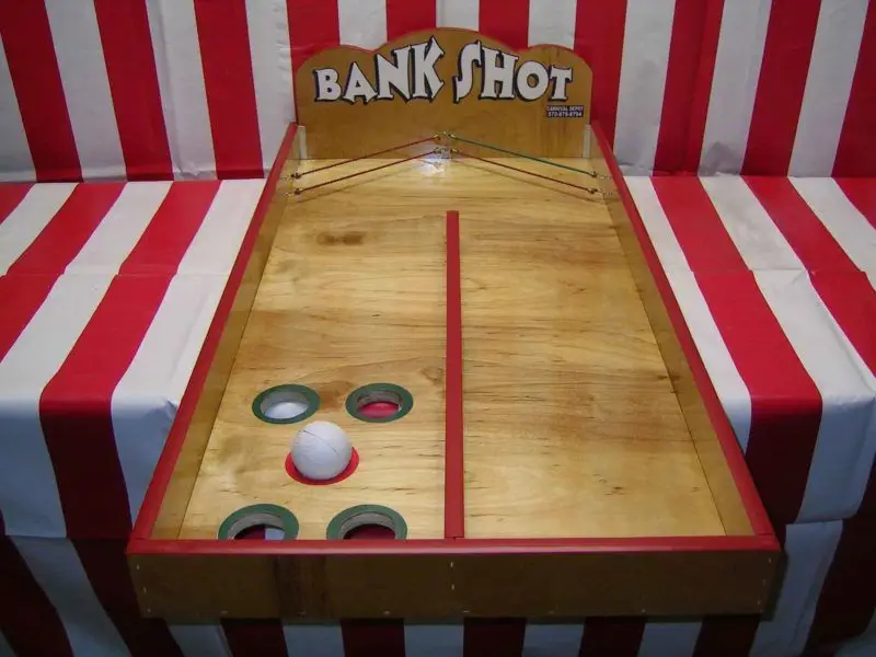 Bank Shot Challenge - Participants take aim, attempting precise bank shots with balls into designated targets. Ideal for friendly competition, this interactive game adds excitement to events and parties