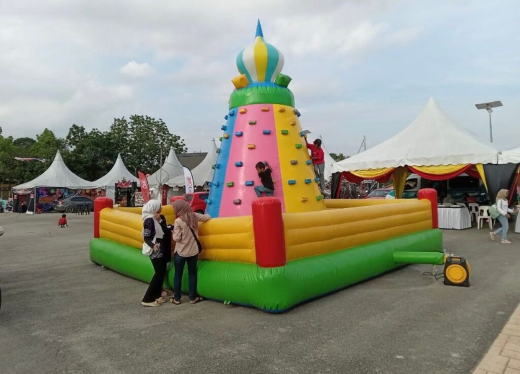 Rock Climbing Inflatable Challenge - Participants scale the heights of an inflatable rock wall with harnesses. Ideal for adventure seekers, this interactive game adds excitement to events and parties.