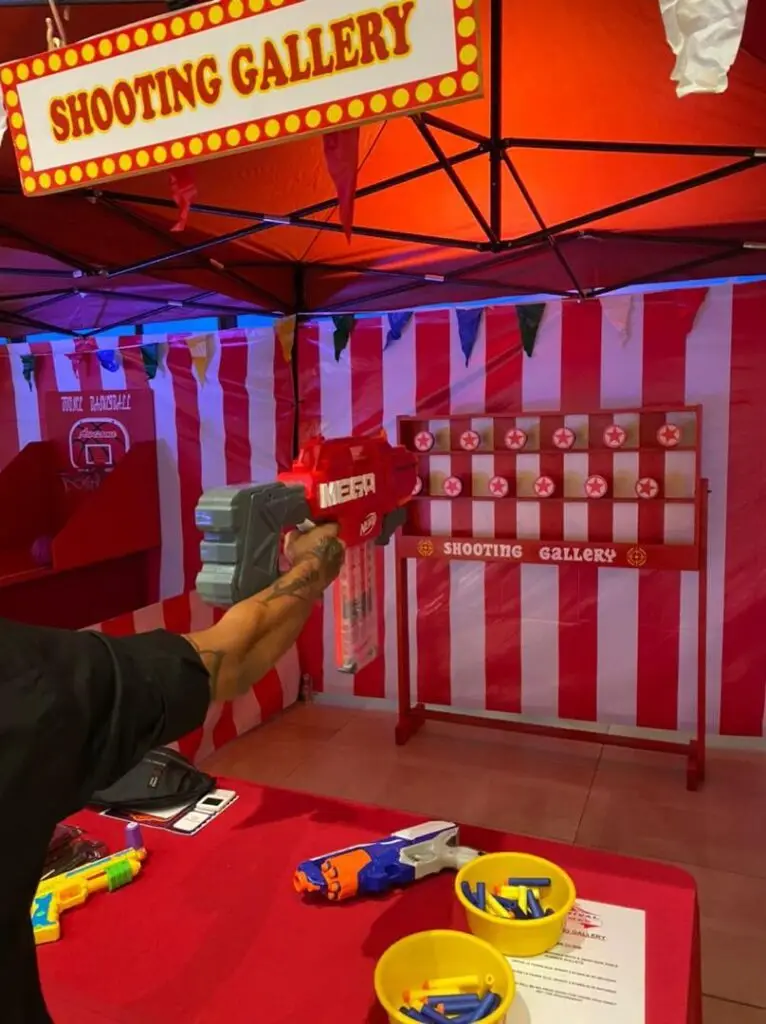 Shooting Gallery Experience - Participants take aim and test their marksmanship skills in a dynamic shooting experience. Ideal for friendly competition, this interactive attraction adds skill and precision to events and parties.